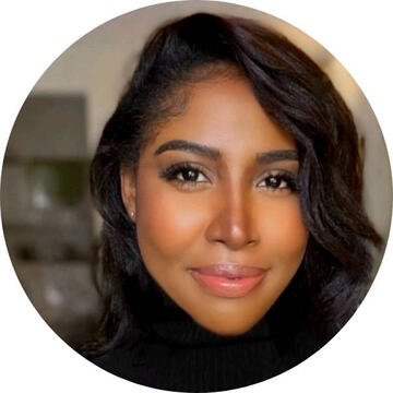 headshot of a black woman wearing a black polo neck, slightly smiling at the camera